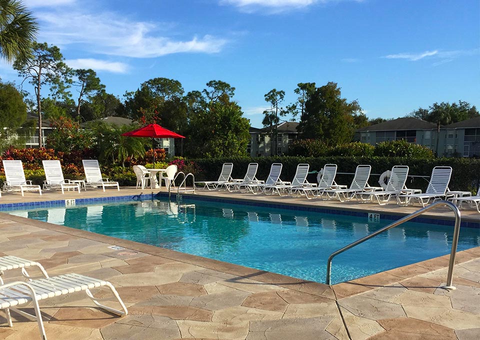 pool with lounge chairs and tables - New Waterford at Berkshire Lakes Condominium Association